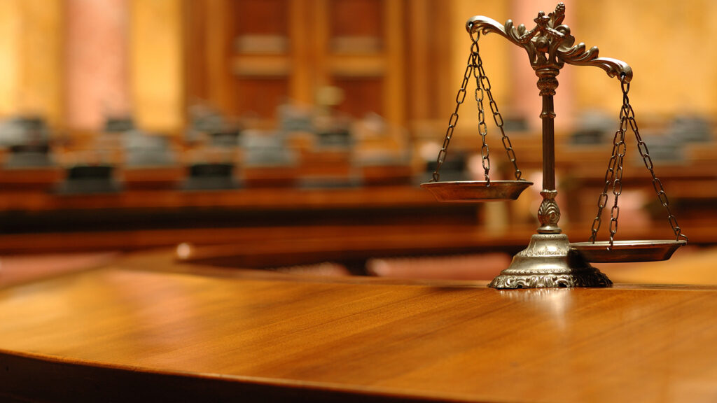 Symbol of law and justice in the empty courtroom, law and justice concept.